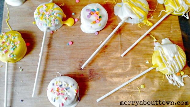Candy-dipped peanut butter pops on wood table