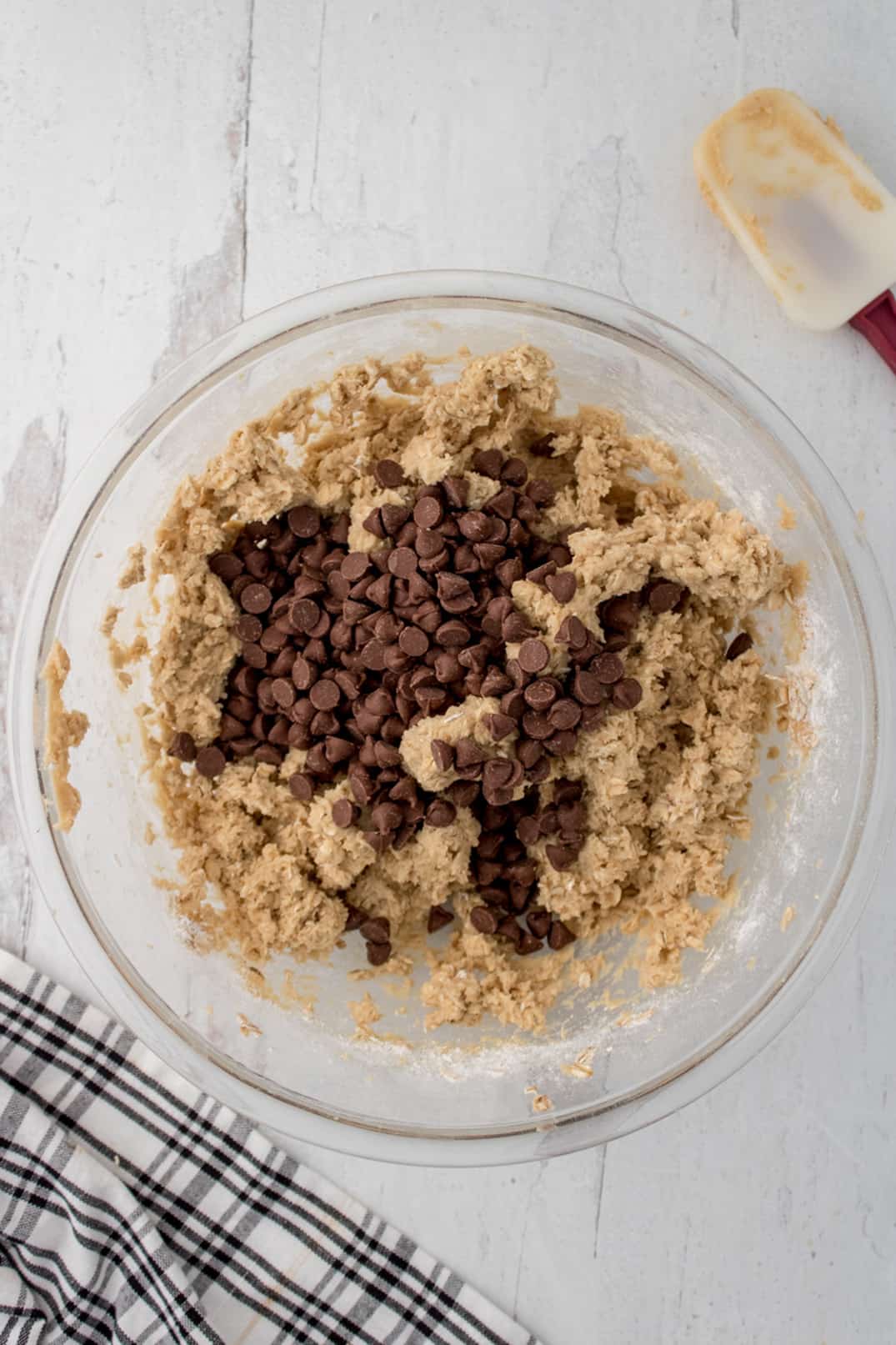 Adding chocolate chips into cookie batter