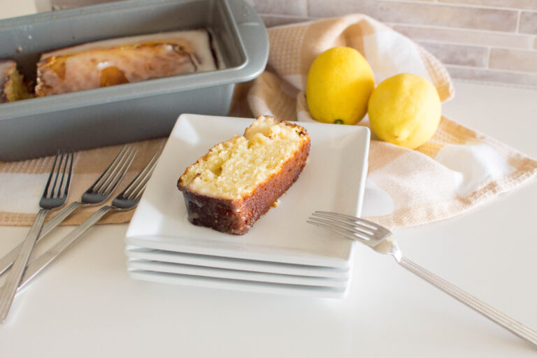 Glazed Lemon Loaf slice on a white square plate