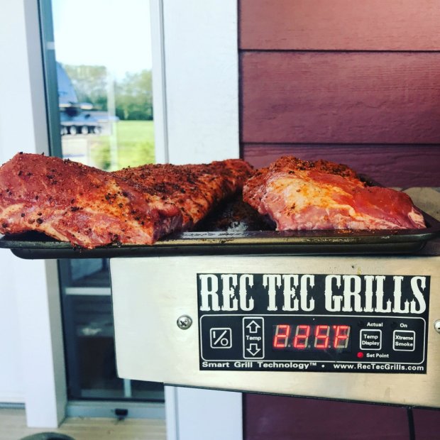 Smoked baby back ribs covered in dry rub