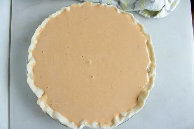 Creamy pumpkin pie ready to bake