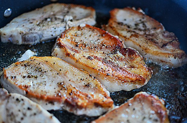 Browning pork chops in pan