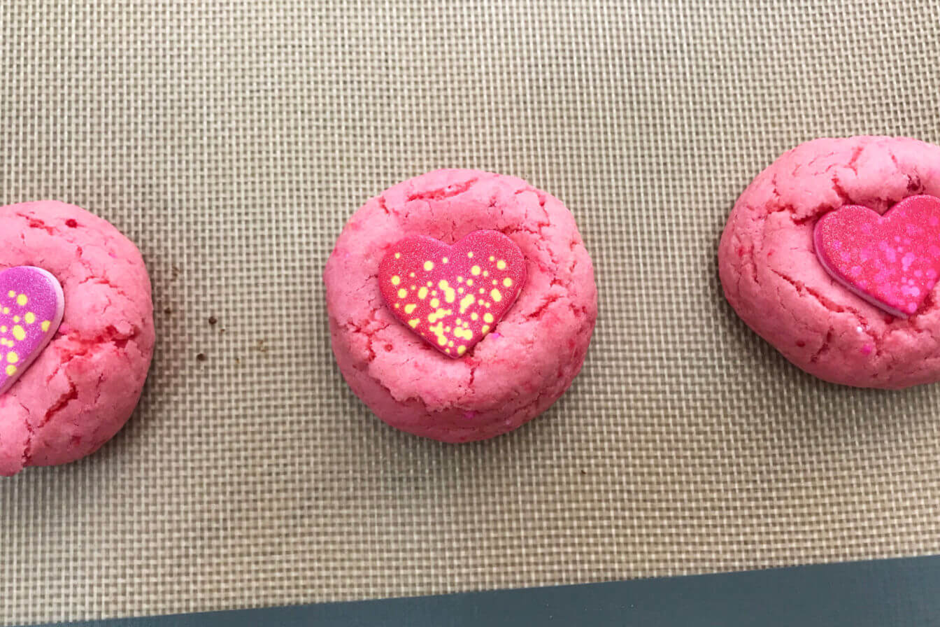 Push candy hearts into cookies