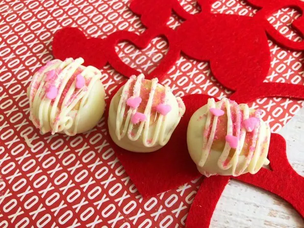 white chocolate peanut butter balls with pink sprinkles