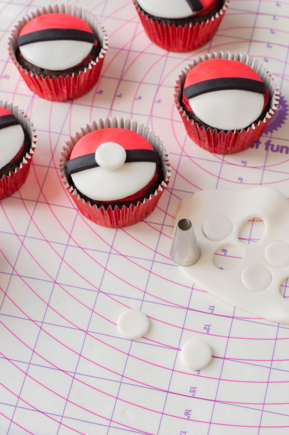 Adding the finishing touch to pokemon cupcakes