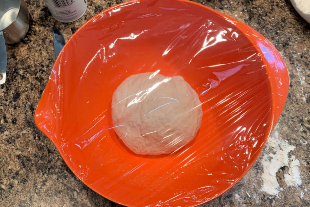 Put the snack pizza dough in a bowl to rise