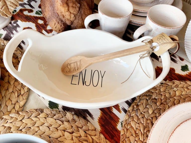 White bowl with handles that says Enjoy