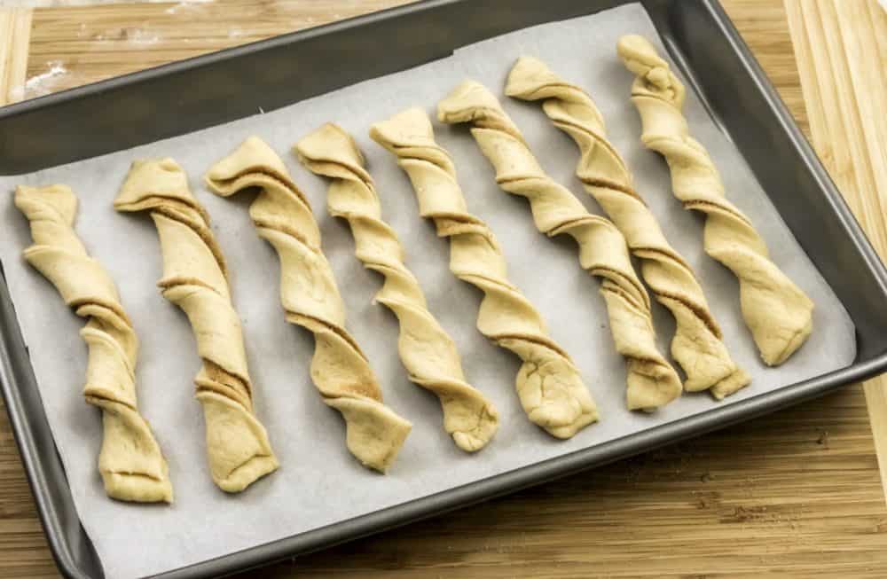 twisting dough to make baked churros