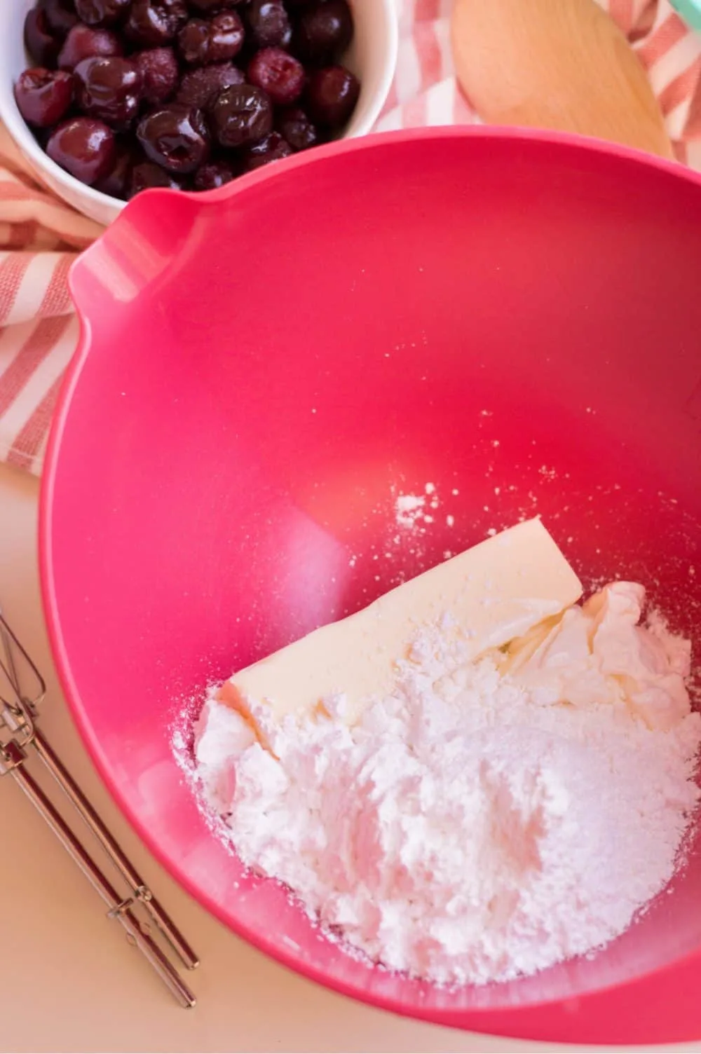 Mixing bowl of softened butter, Greek yogurt and confectioners sugar.