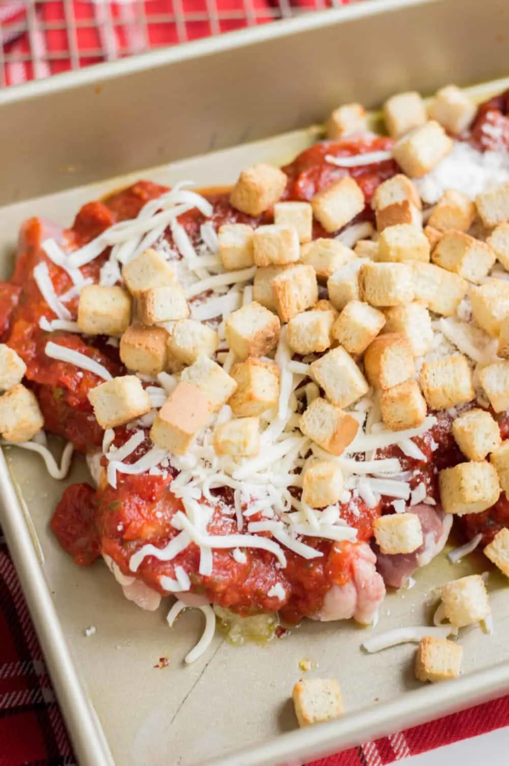 topping chicken parm with croutons