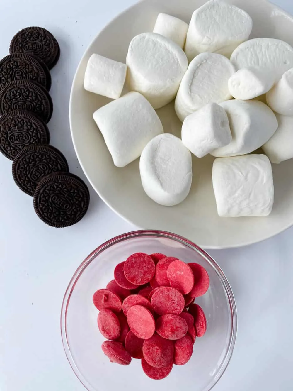 3 ingredients needed for Dr. Seuss Marshmallow Hats - chocolate sandwich cookies, marshmallows, and red candy melts
