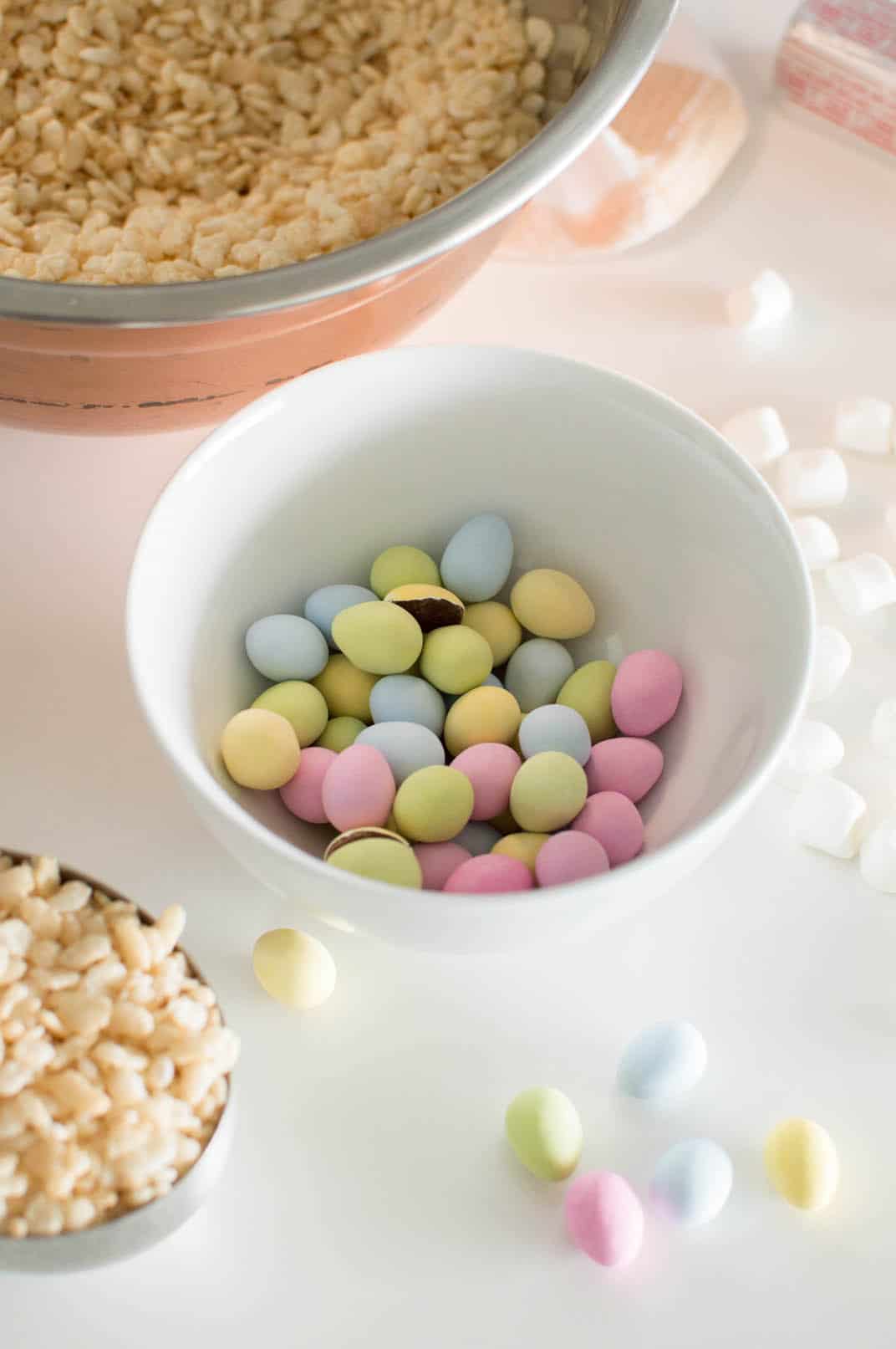 Mini Egg candies in a white bowl surrounded by other ingredients