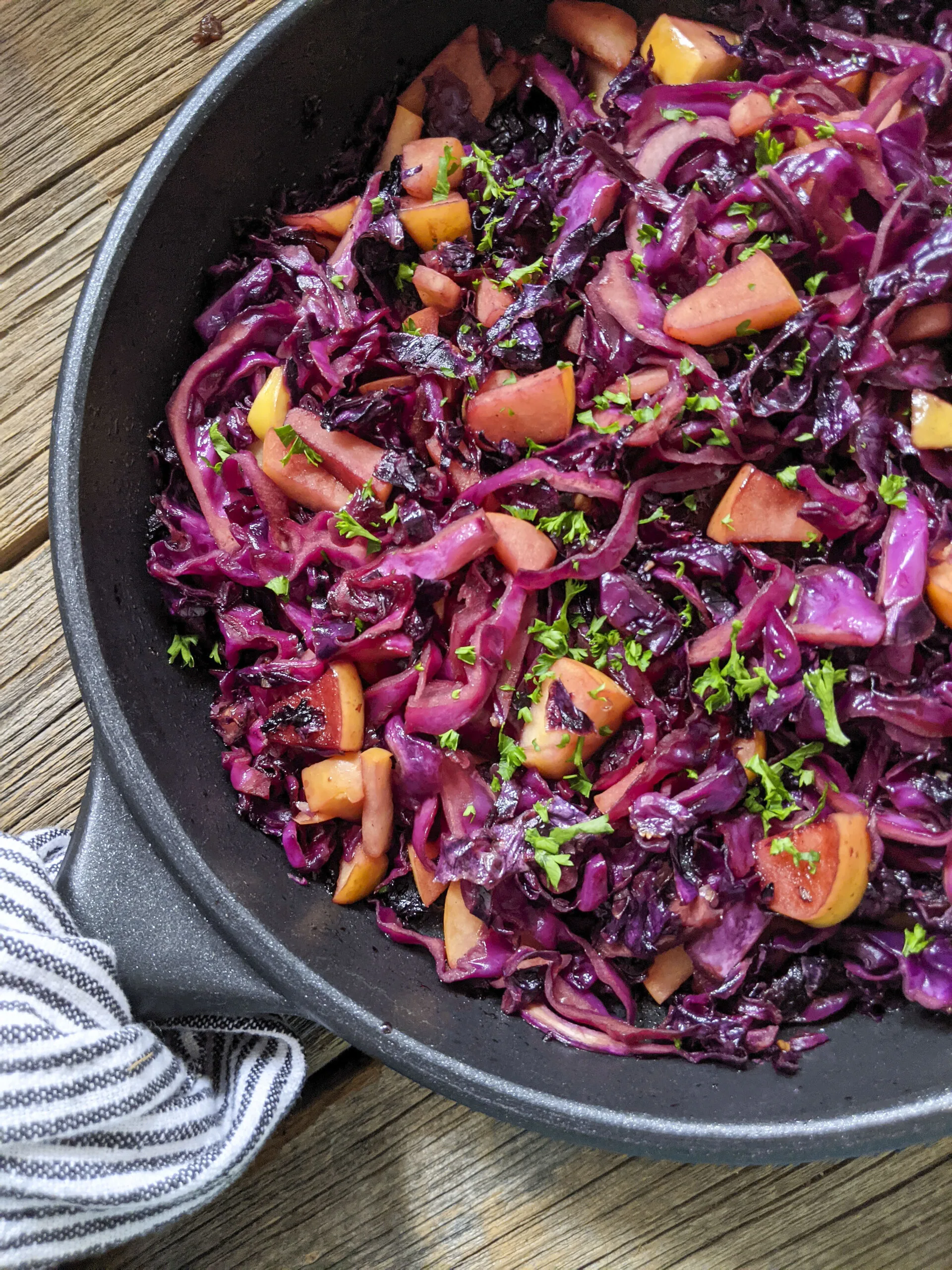 sweet and sour cabbage with apples in a skillet