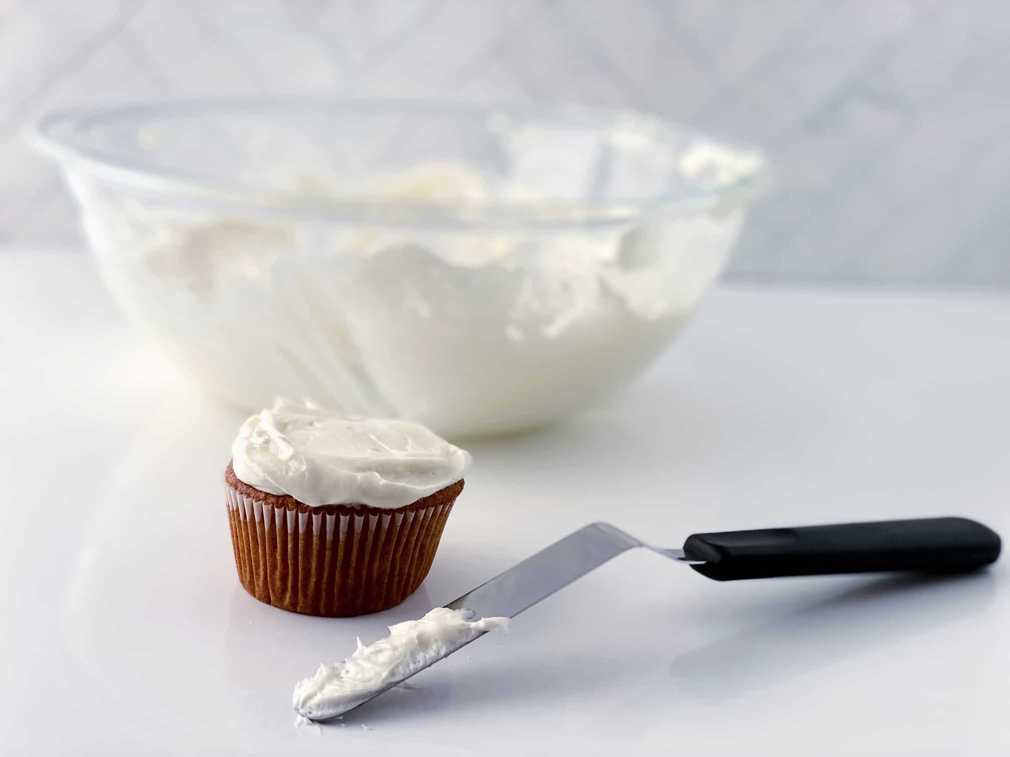 Spreading Cream Cheese Frosting on a Cupcake