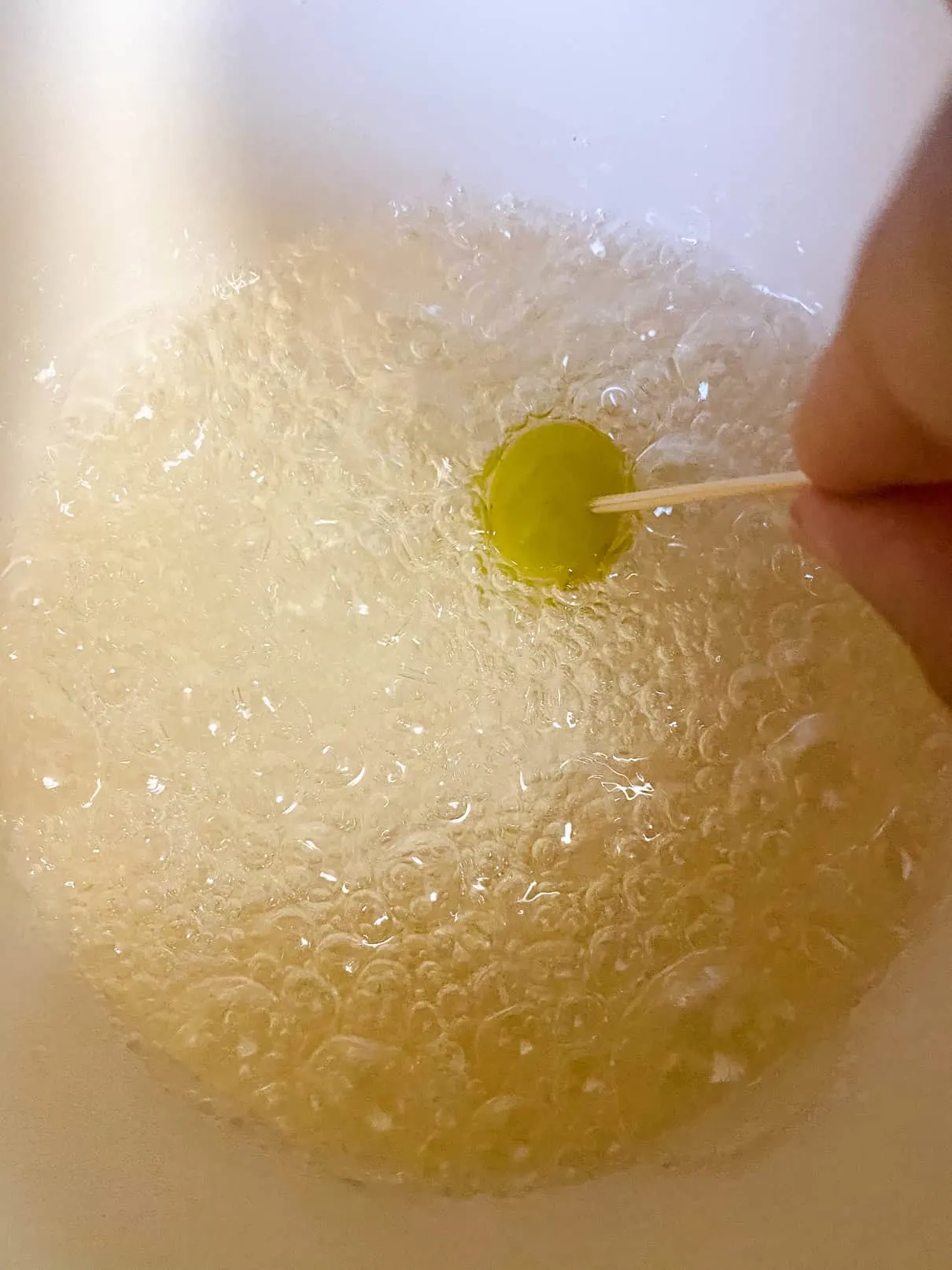 Dipping fruit into boiling sugar water