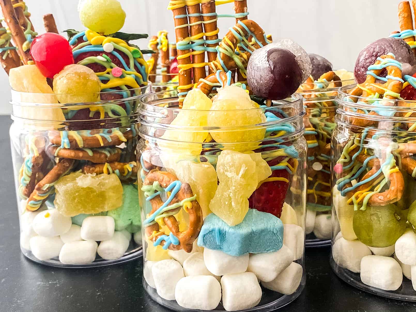 Got a major sweet tooth? Then our Sweet Jarcuterie is a MUST! Indulge in a jar filled with delicious sweets like candied fruit, chocolate-covered pretzels, and marshmallows.
