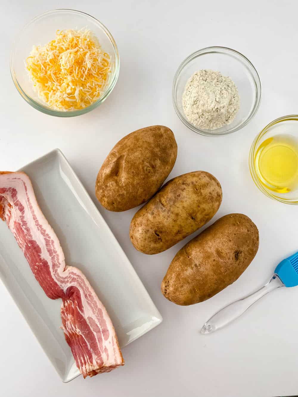 Ingredients for Potato Poppers laid out on a white surface