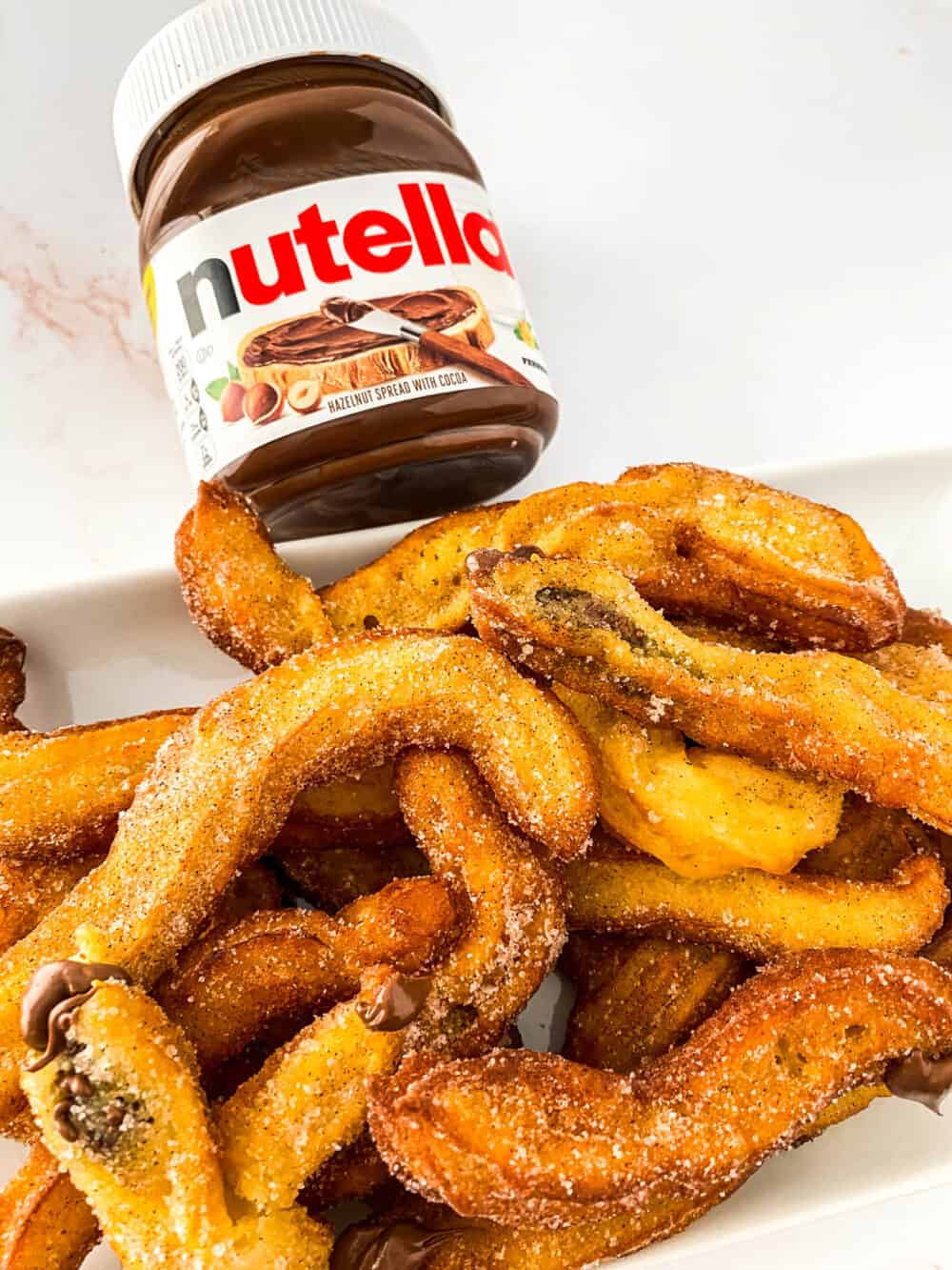 Churros and Nutella: a combination that will satisfy ANY sweet tooth! The best part to my Nutella Churros is that they’re STUFFED with melted Nutella and absolutely delicious!