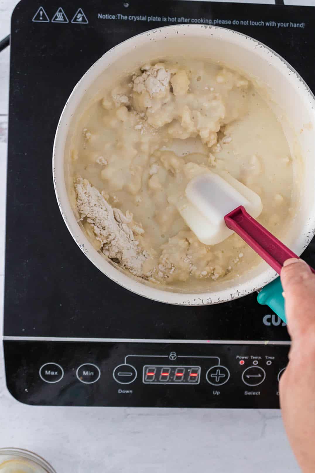 Cooking a dough batter to make a batch of churros