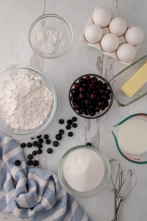 Ingredients in glass bowls to make blueberry muffins