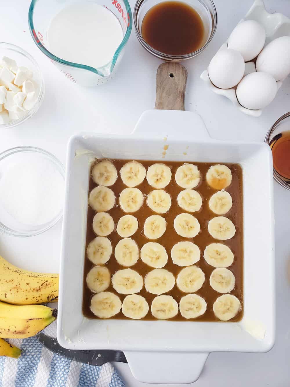 Adding caramel and a layer of sliced banana to a white casserole dish