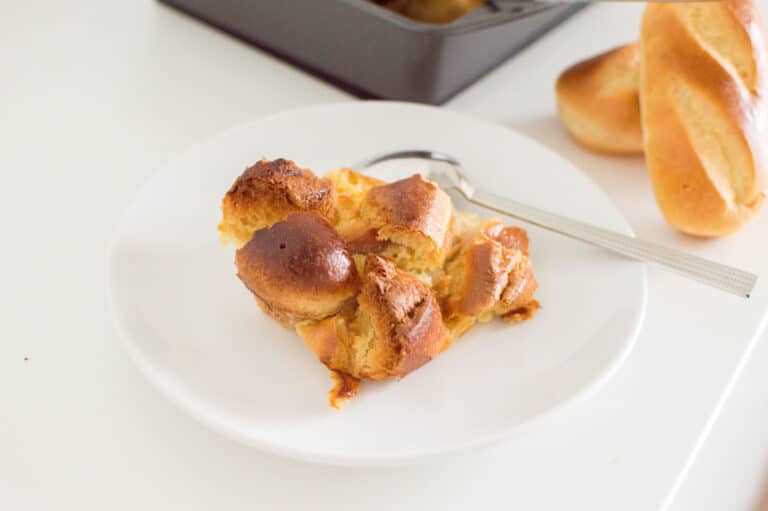 Close-up of a slice of bread pudding on a white plate
