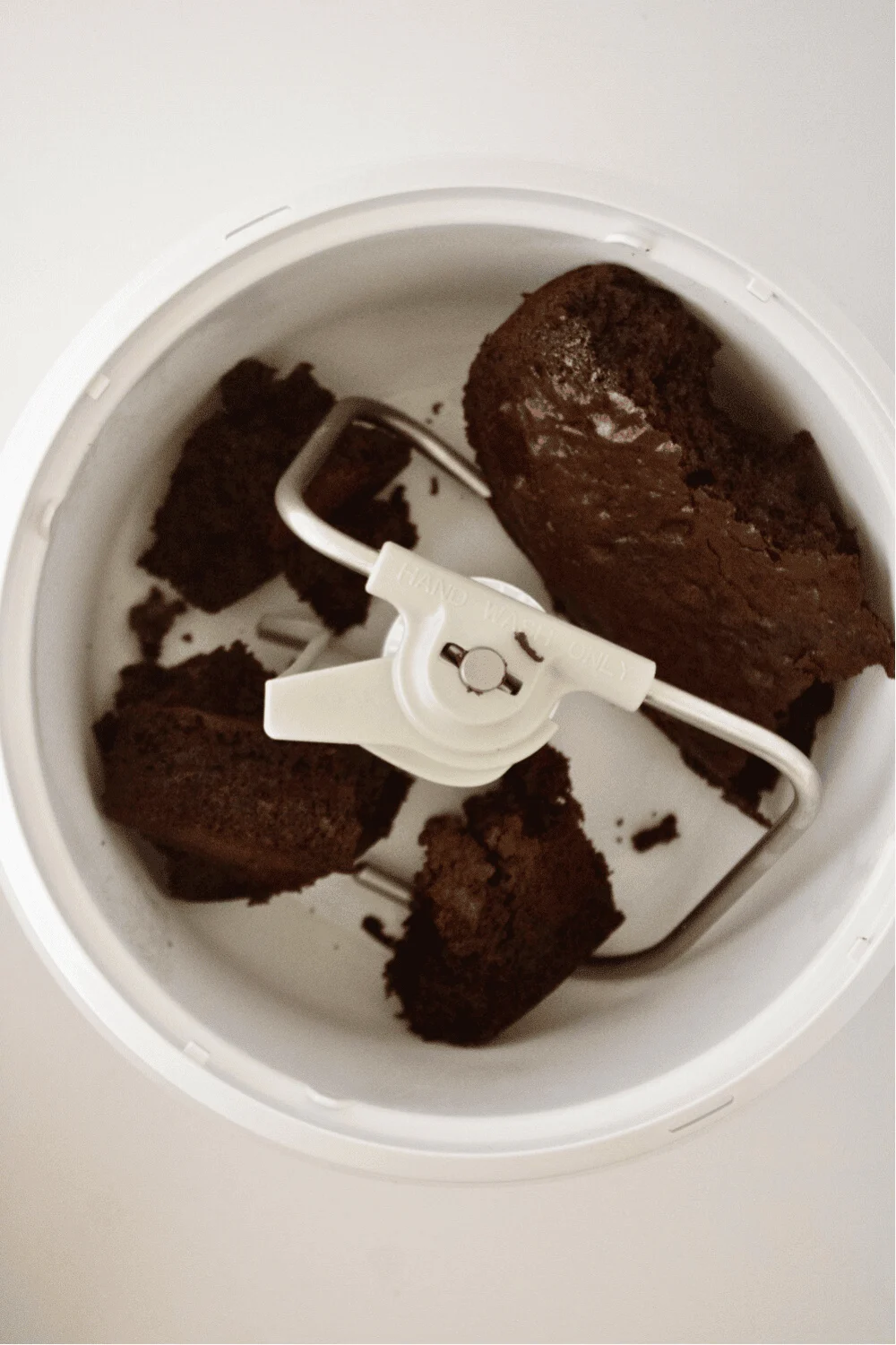 Blending warm cake in a stand mixer to make cake pop dough.
