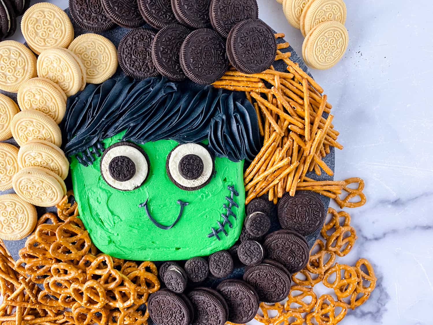 Baby Frankenstein Halloween Frosting Board on marble background