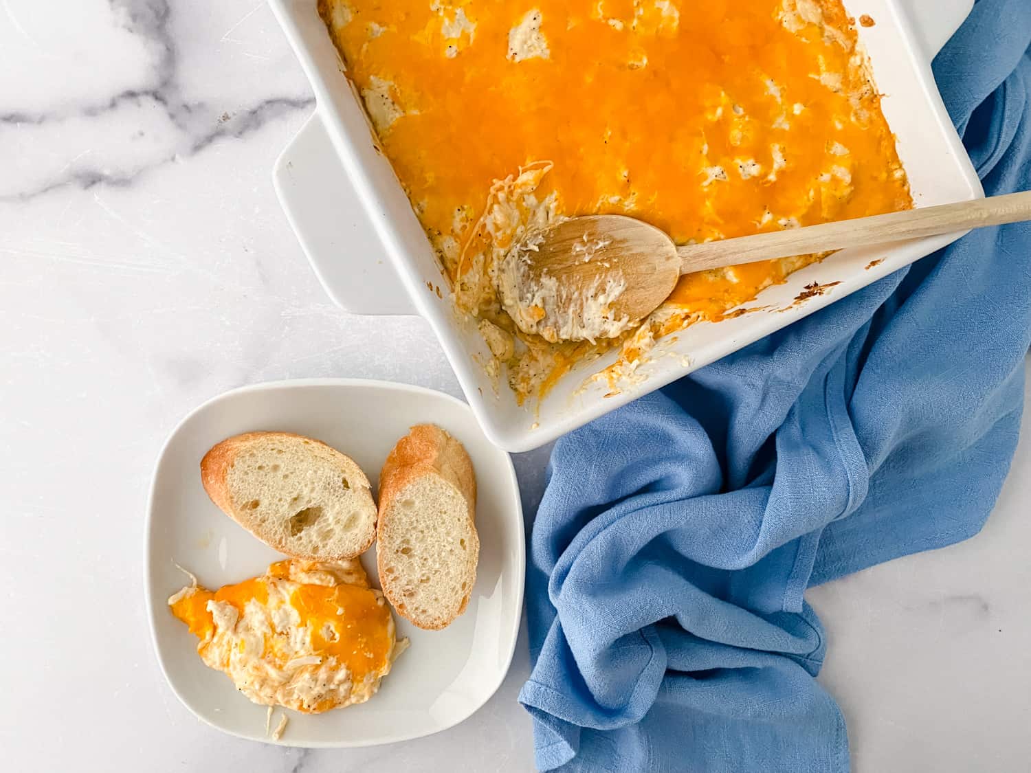 Completed Maryland Crab Dip with blue towel and baguette slices
