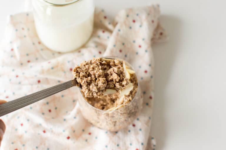 Cinnamon Roll Overnight Oats in a glass with a spoon