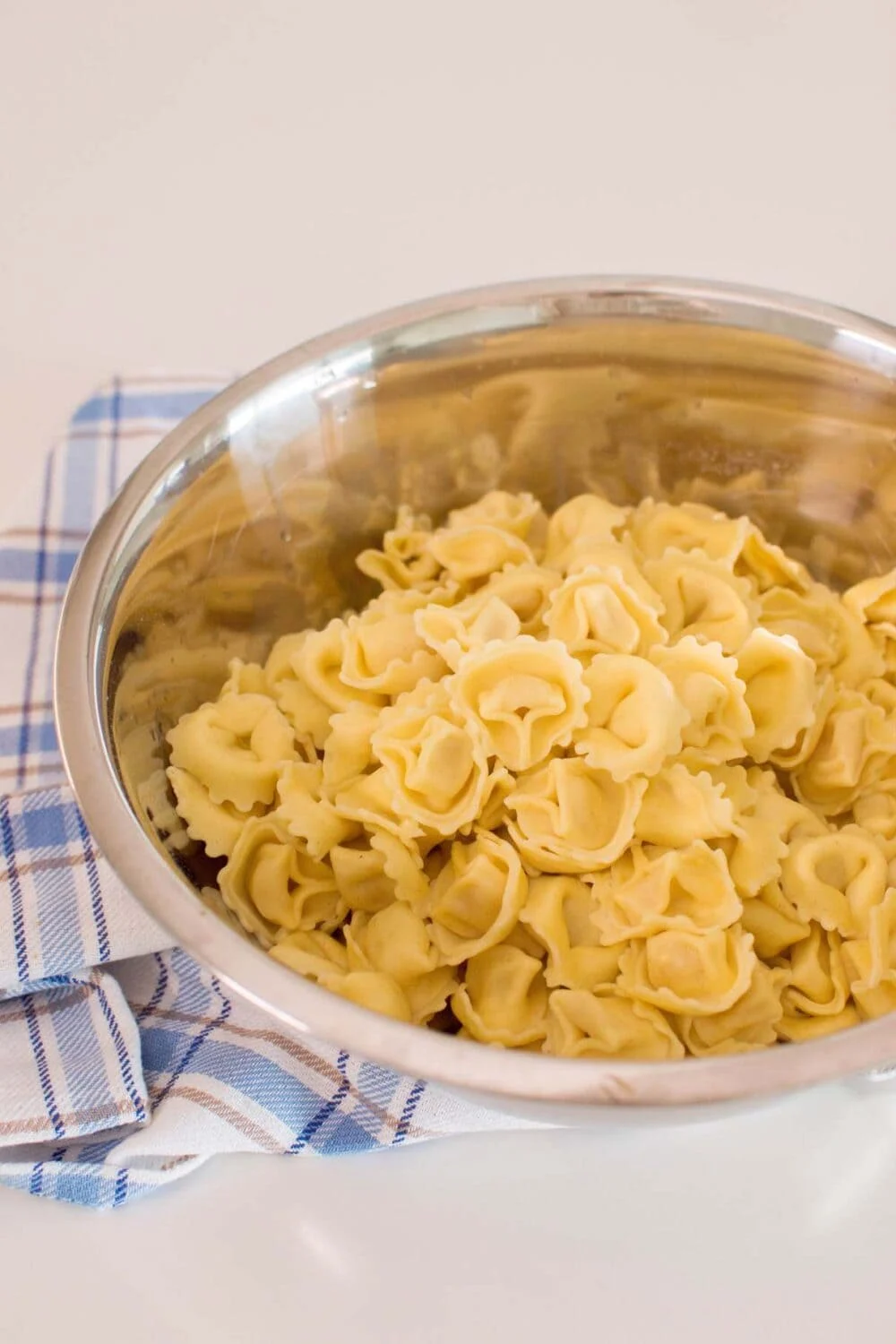 Tortellini in a stainless steel bowl
