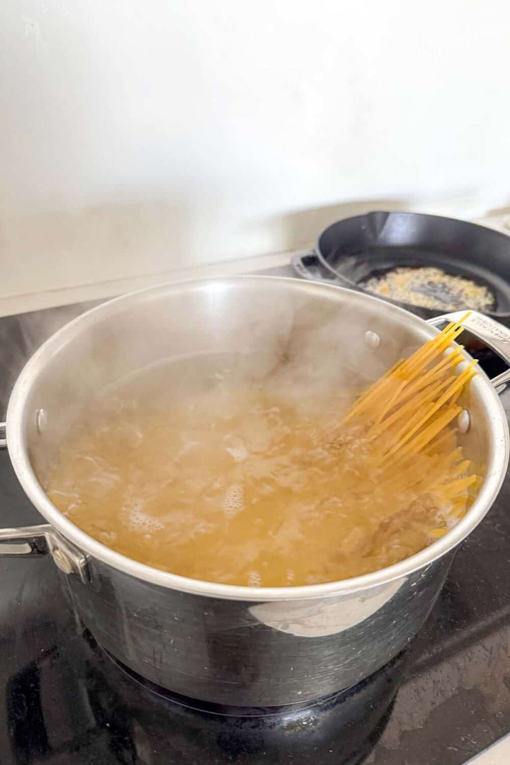 Boiling spaghetti for our homemade Artichoke Pesto Pasta recipe