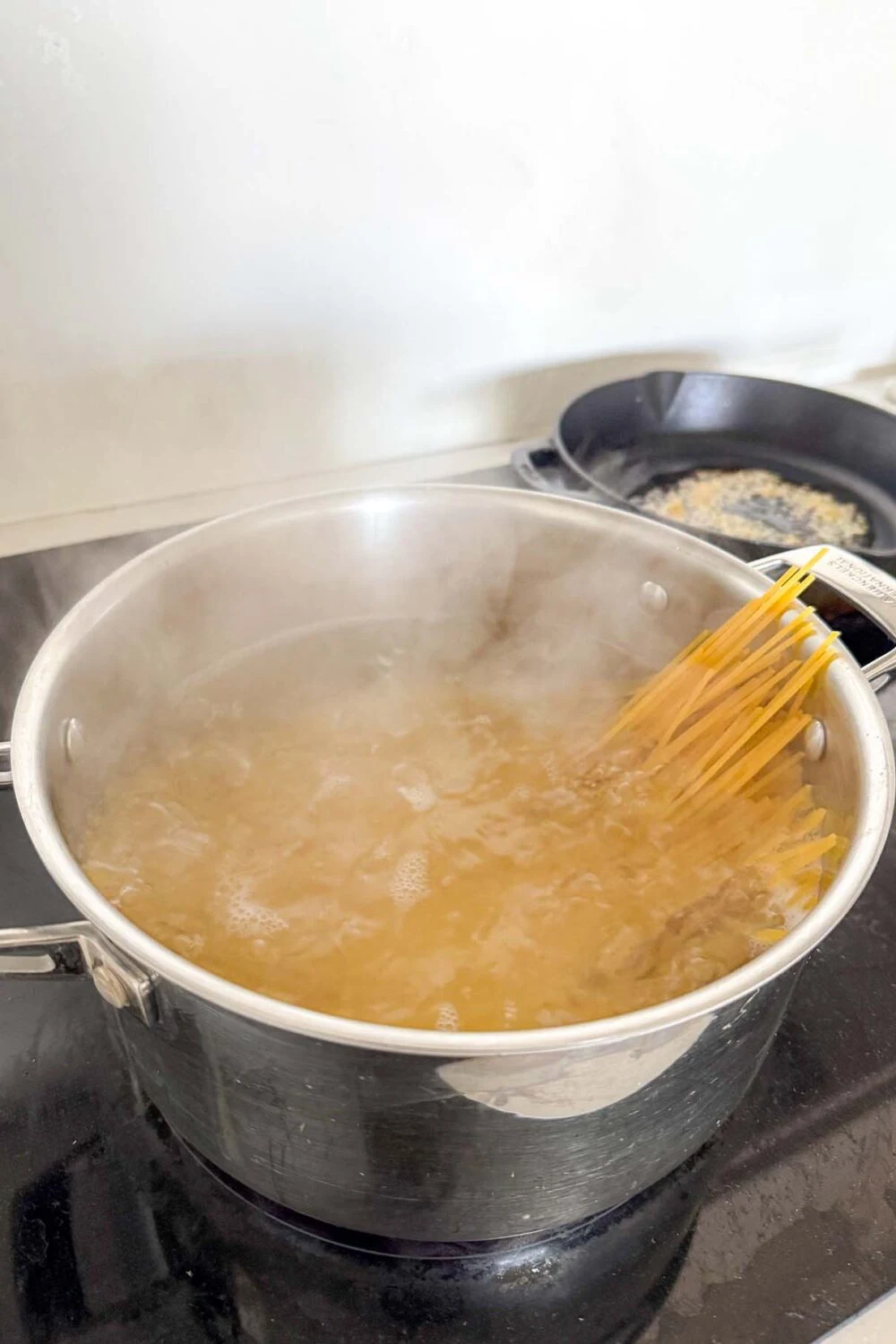 Boiling spaghetti for our homemade Artichoke Pesto Pasta recipe