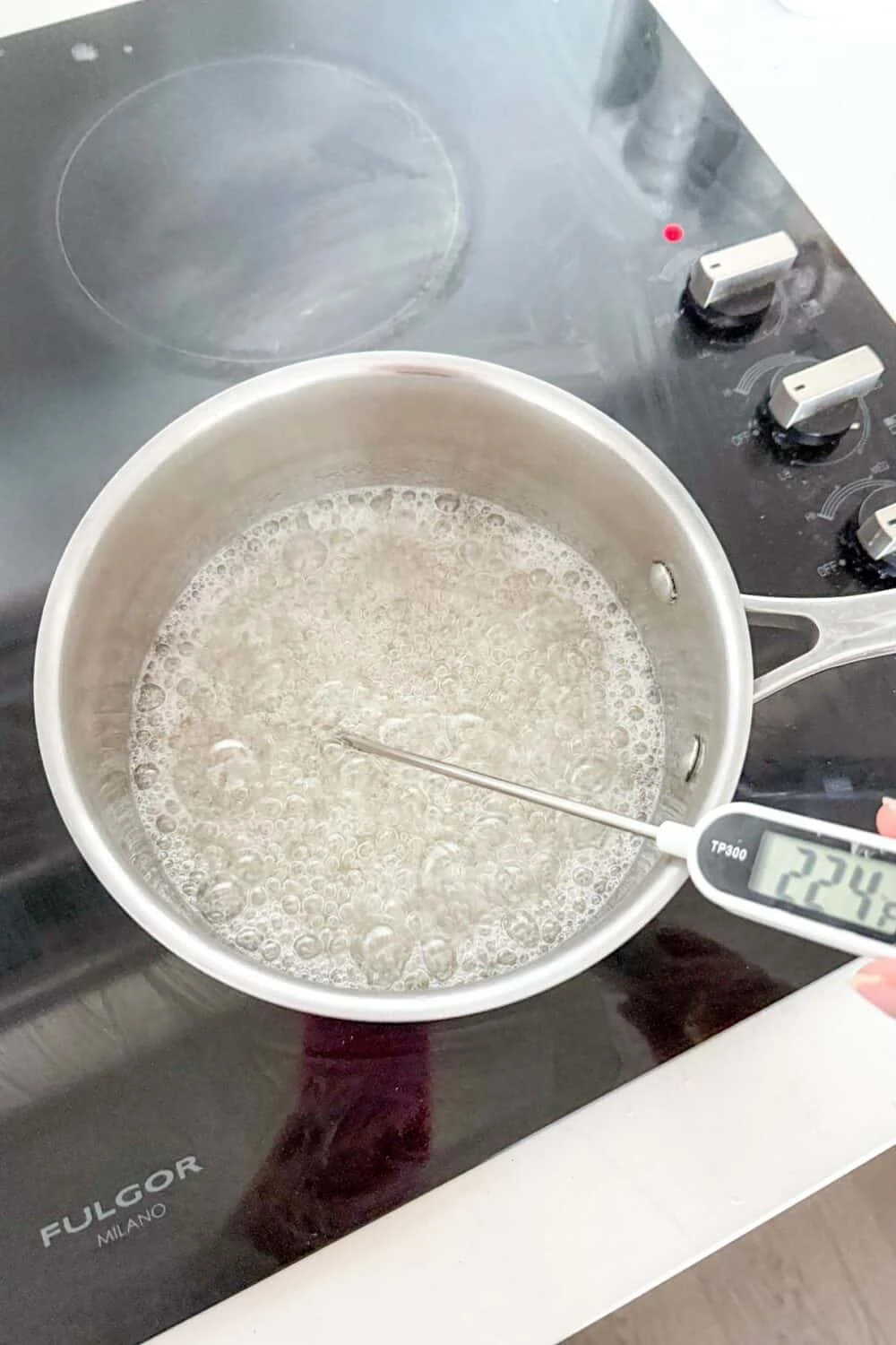 Waiting for water and sugar to reach 300 degrees to make peanut brittle