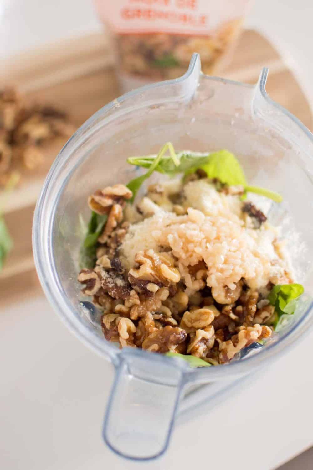 Processed pesto sauce in a blender, mid-blend
