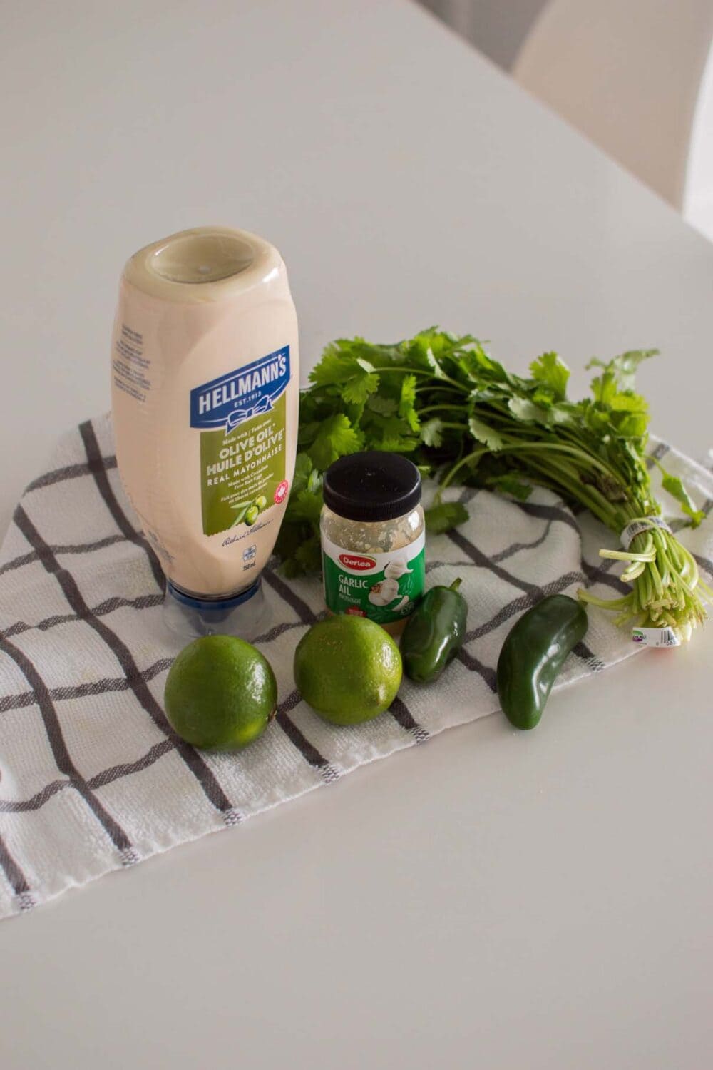 Ingredients laid out on a white table to make an Easy Jalapeno Aioli Recipe