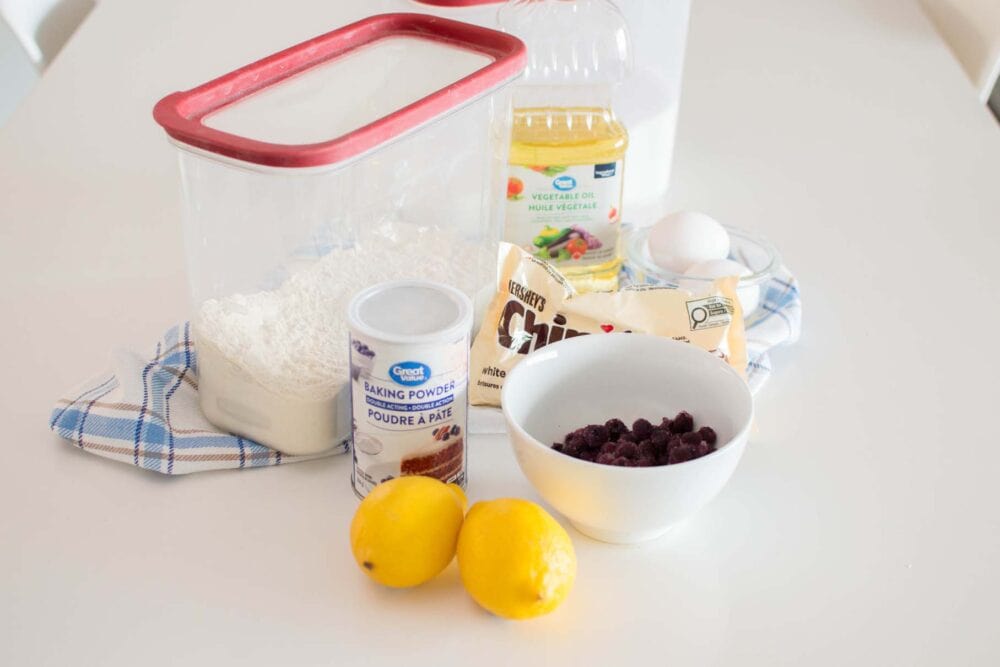 Ingredients to make Lemon Blueberry White Chocolate Muffins on a white table