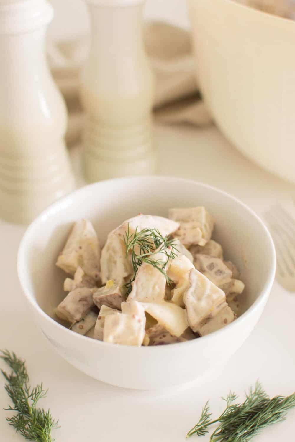 Overhead view of loaded dill pickle potato salad styled for serving