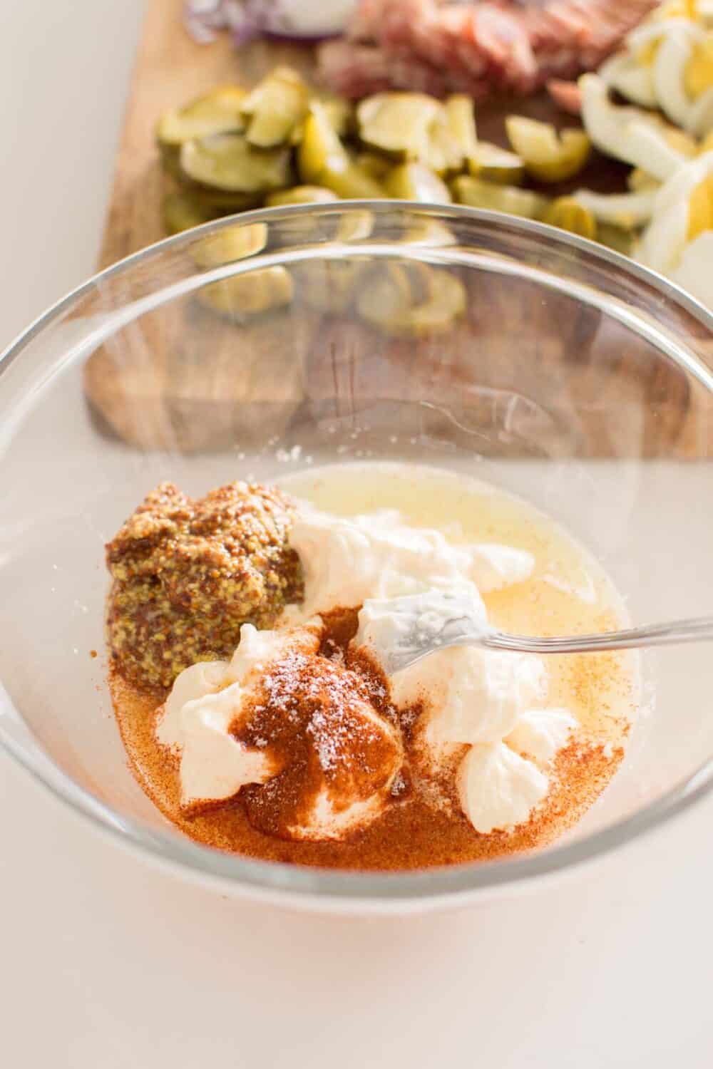 Creamy dill pickle dressing being mixed for potato salad recipe