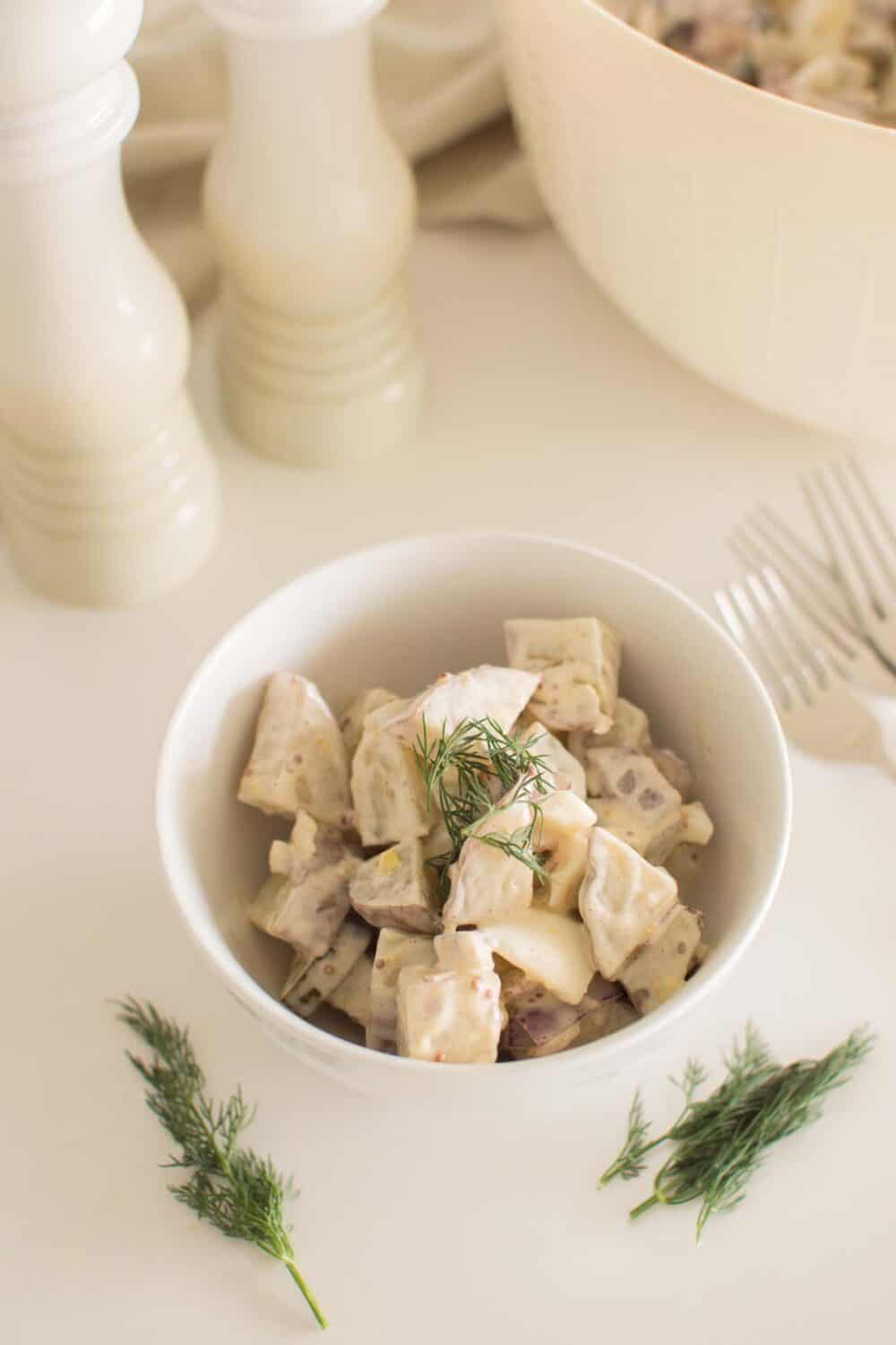Homemade loaded dill pickle potato salad served in a white bowl