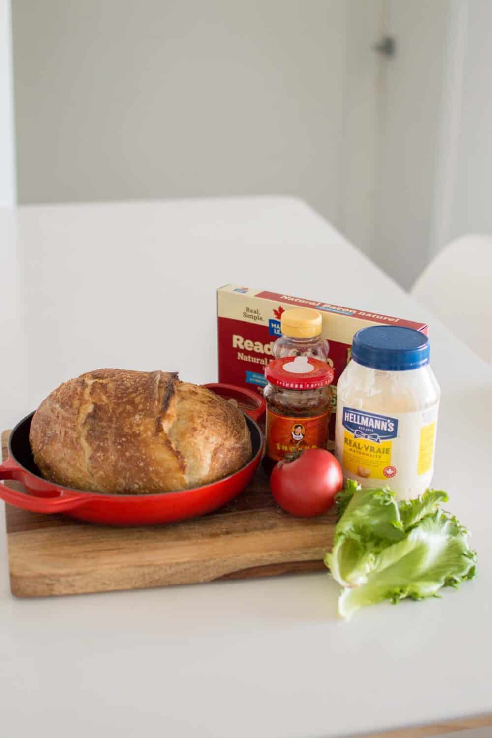 Ingredients for hot honey BLT including sourdough bread, bacon, and sauces