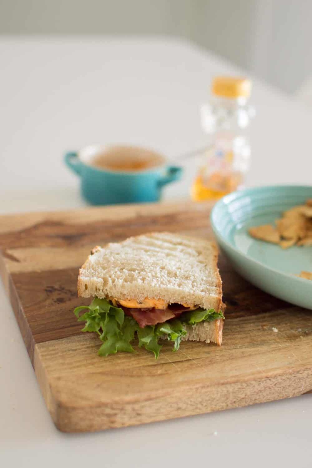 Overhead view of hot honey BLT sandwich with crispy bacon and toasted bread
