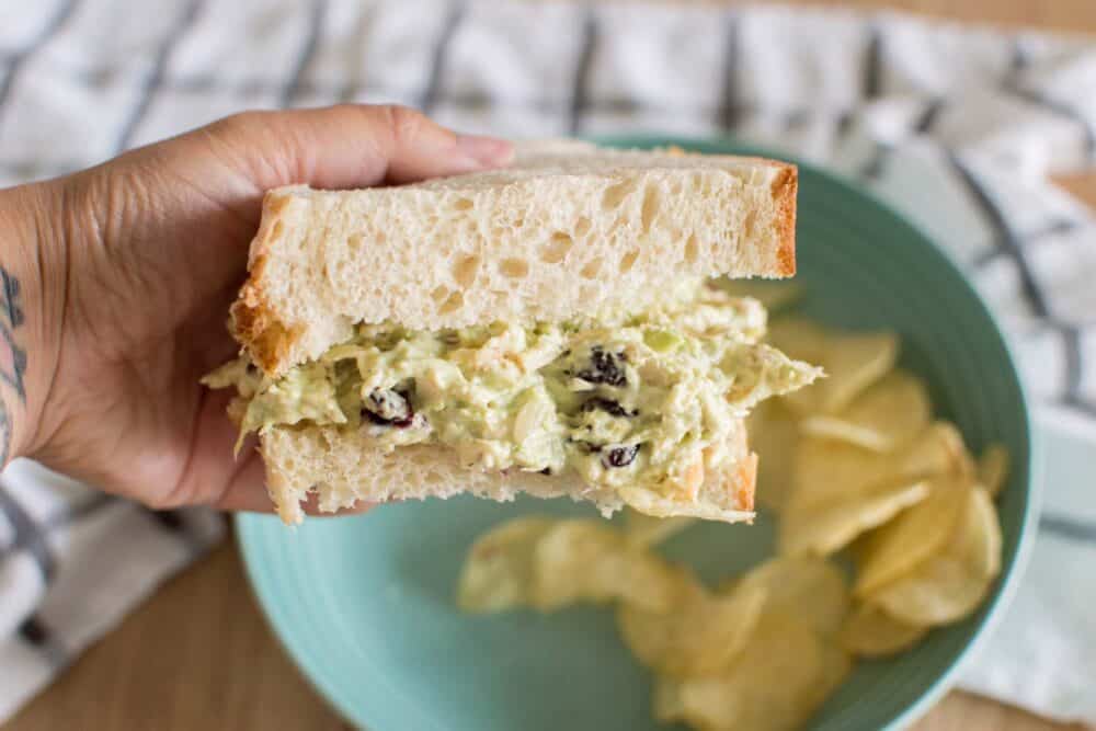 Creamy avocado ranch chicken salad sandwich with potato chips