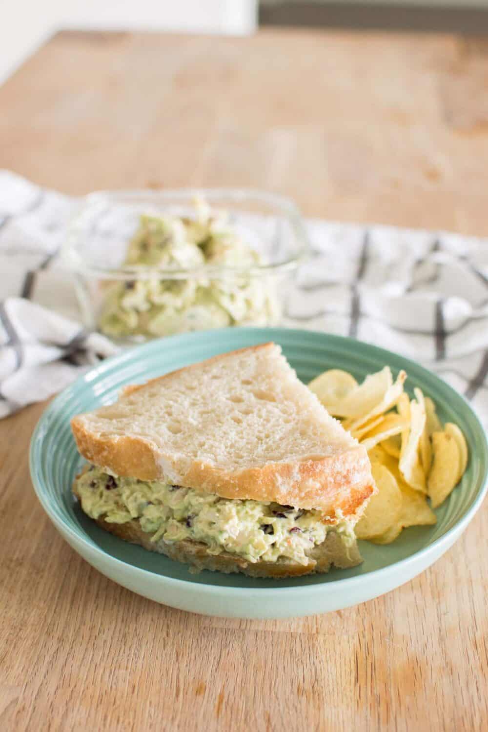 Close-up of creamy avocado ranch chicken salad with slivered almonds and craisins