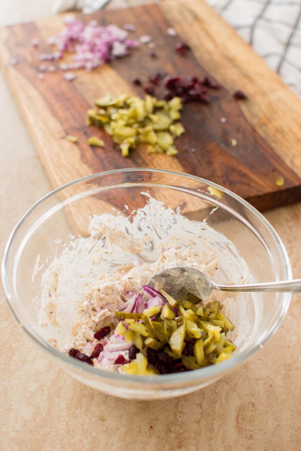 Chopped dill pickles and craisins ready to add to shredded chicken