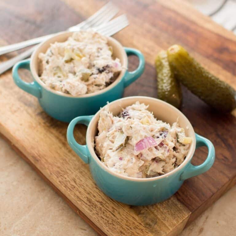 Dill Pickle Chicken Salad served in small bowls with whole dill pickles